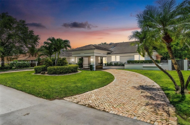 17940 SW 83rd Ave, Palmetto Bay, FL 33157 - mediterranean / spanish-style house featuring curved driveway, a fenced front yard, and stucco siding
