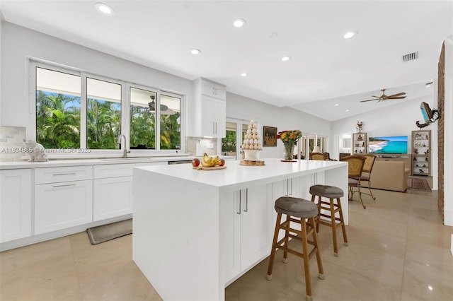 17940 SW 83rd Ave, Palmetto Bay, FL 33157 - kitchen featuring backsplash, recessed lighting, a kitchen island, white cabinetry, and light countertops