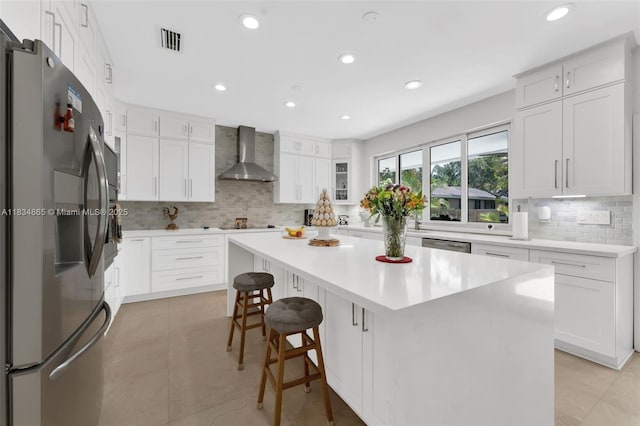 17940 SW 83rd Ave, Palmetto Bay, FL 33157 - kitchen featuring appliances with stainless steel finishes, wall chimney exhaust hood, backsplash, a center island, and recessed lighting