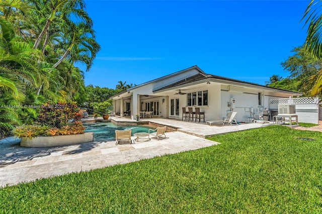 17940 SW 83rd Ave, Palmetto Bay, FL 33157 - rear view of house featuring a ceiling fan, a lawn, a patio area, stucco siding, and an outdoor pool
