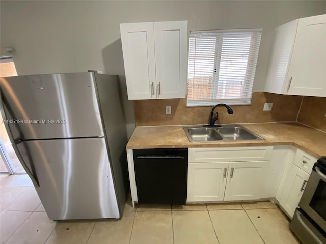 6124 SW 39th St, Miramar, FL 33023 - kitchen with freestanding refrigerator, dishwasher, white cabinets, and light tile patterned flooring