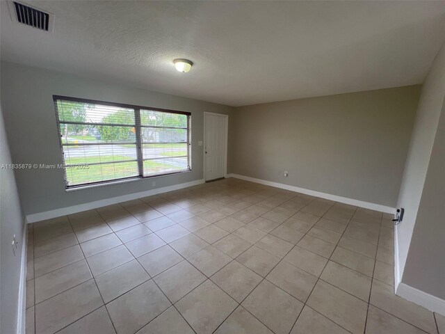 6837 NW 28th St, Sunrise, FL 33313 - unfurnished room with light tile patterned flooring and a textured ceiling