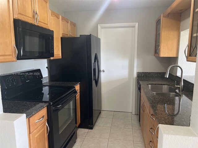 6837 NW 28th St, Sunrise, FL 33313 - kitchen featuring black appliances, dark stone counters, and light tile patterned floors
