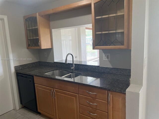 6837 NW 28th St, Sunrise, FL 33313 - kitchen with dishwasher, glass insert cabinets, dark stone counters, and brown cabinetry
