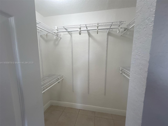 6837 NW 28th St, Sunrise, FL 33313 - walk in closet featuring tile patterned floors