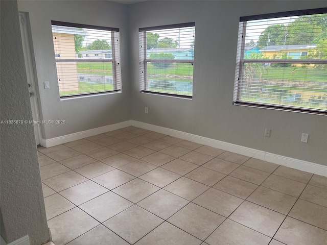 6837 NW 28th St, Sunrise, FL 33313 - empty room with light tile patterned floors and plenty of natural light