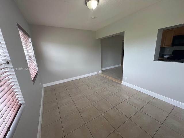 6837 NW 28th St, Sunrise, FL 33313 - empty room featuring light tile patterned flooring and baseboards