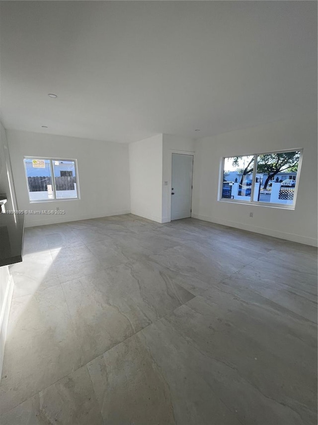 1310 Sharazad Blvd, Opa Locka, FL 33054 - unfurnished living room with plenty of natural light and concrete floors