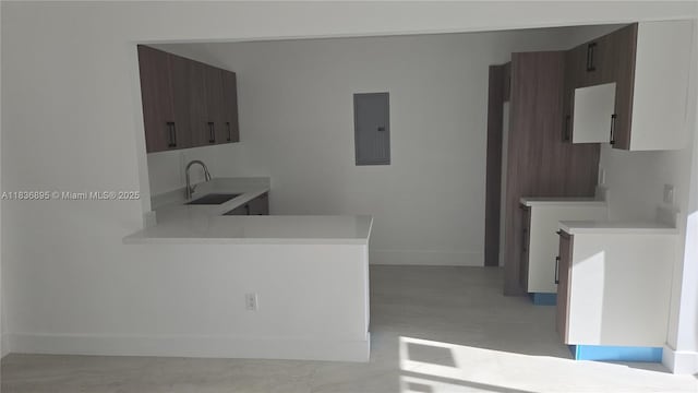 1310 Sharazad Blvd, Opa Locka, FL 33054 - kitchen featuring electric panel, light countertops, and a peninsula