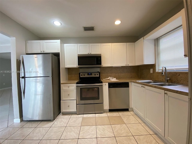 7521 Indigo St, Miramar, FL 33023 - kitchen featuring stainless steel appliances, white cabinetry, decorative backsplash, and recessed lighting