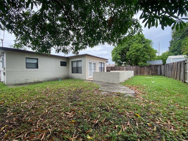 7521 Indigo St, Miramar, FL 33023 - back of property with a fenced backyard and stucco siding