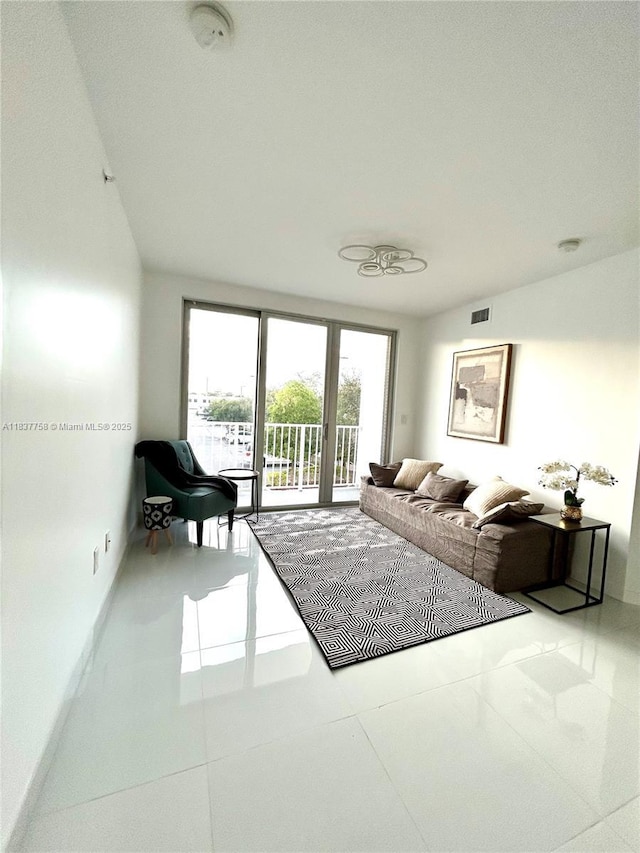 2651 NE 212th Ter Unit 202, Aventura, FL 33180 - living area featuring baseboards and tile patterned floors