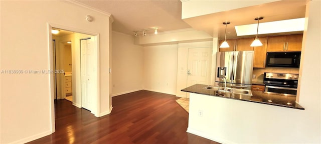 2000 N Bayshore Dr Unit 509, Miami, FL 33137 - kitchen featuring appliances with stainless steel finishes, dark countertops, dark wood-style flooring, ornamental molding, and a peninsula