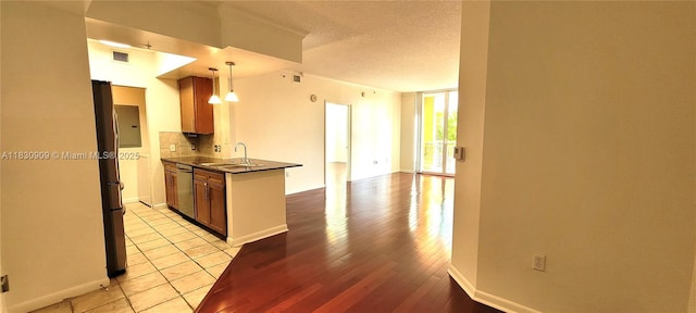 2000 N Bayshore Dr Unit 509, Miami, FL 33137 - kitchen with dark countertops, a peninsula, backsplash, a textured ceiling, and open floor plan