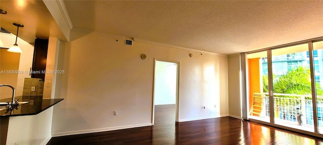 2000 N Bayshore Dr Unit 509, Miami, FL 33137 - empty room featuring dark wood-type flooring, ornamental molding, a textured ceiling, and floor to ceiling windows