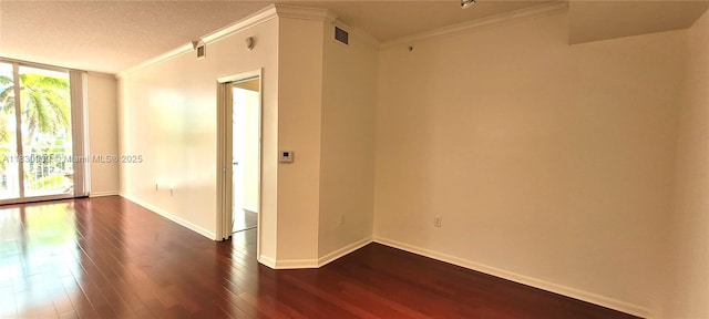 2000 N Bayshore Dr Unit 509, Miami, FL 33137 - unfurnished room featuring dark wood-style floors, crown molding, a wall of windows, and a textured ceiling