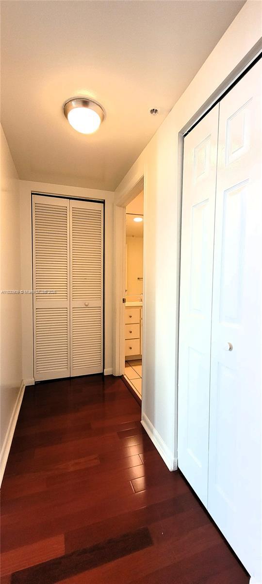 2000 N Bayshore Dr Unit 509, Miami, FL 33137 - hallway featuring baseboards and dark wood finished floors