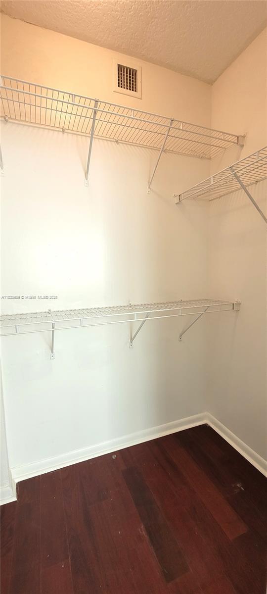 2000 N Bayshore Dr Unit 509, Miami, FL 33137 - walk in closet with dark wood-type flooring