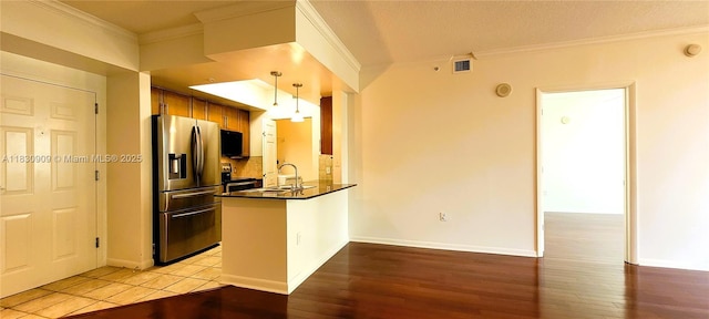 2000 N Bayshore Dr Unit 509, Miami, FL 33137 - kitchen featuring appliances with stainless steel finishes, dark countertops, a peninsula, light wood-style floors, and crown molding