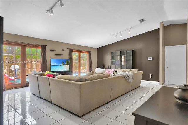 10405 SW 146th Ave, Miami, FL 33186 - living area featuring track lighting, vaulted ceiling, light tile patterned floors, and french doors