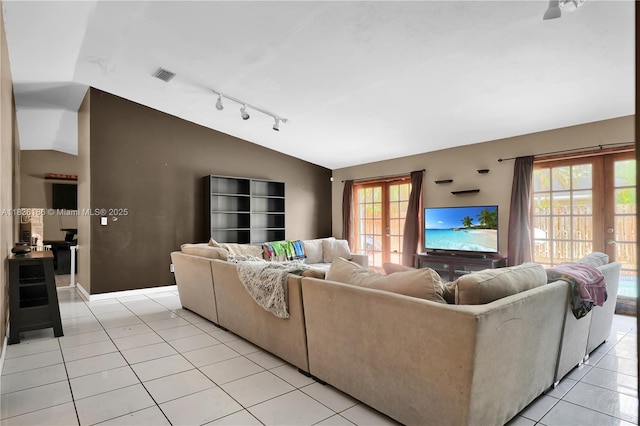 10405 SW 146th Ave, Miami, FL 33186 - living room featuring rail lighting, vaulted ceiling, and light tile patterned floors