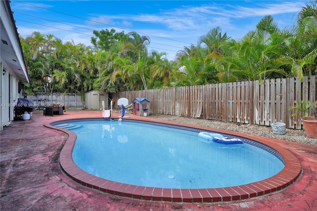 10405 SW 146th Ave, Miami, FL 33186 - view of swimming pool featuring a fenced backyard and a storage shed