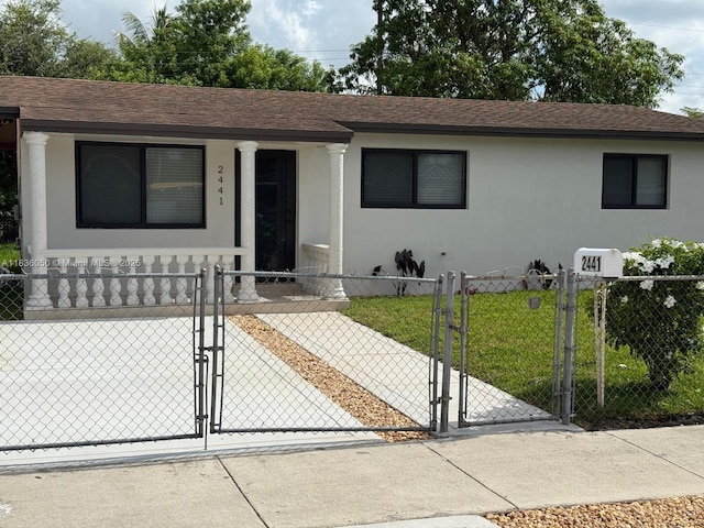 2441 NW 140th St, Opa Locka, FL 33054 - single story home with a gate, a fenced front yard, stucco siding, and a shingled roof
