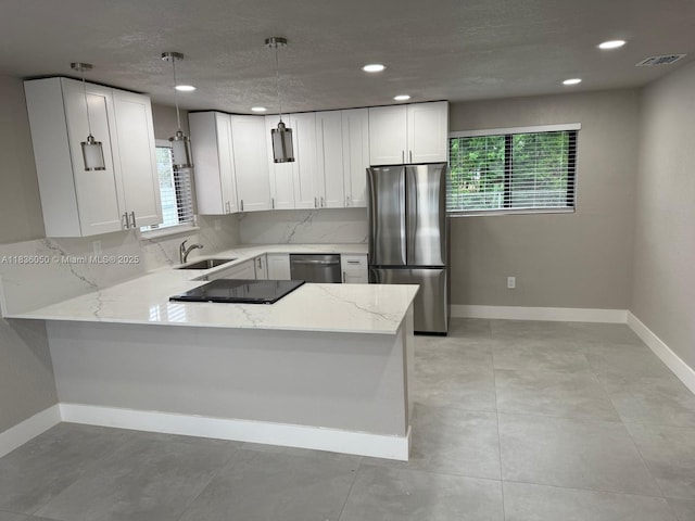 2441 NW 140th St, Opa Locka, FL 33054 - kitchen with stainless steel appliances, light stone countertops, a peninsula, tasteful backsplash, and recessed lighting