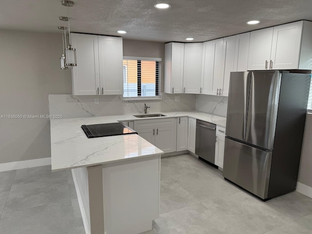 2441 NW 140th St, Opa Locka, FL 33054 - kitchen featuring appliances with stainless steel finishes, a peninsula, white cabinetry, a textured ceiling, and recessed lighting