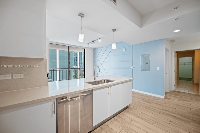 999 SW 1st Ave Unit 1615, Miami, FL 33130 - kitchen featuring stainless steel dishwasher, white cabinetry, electric panel, decorative light fixtures, and light countertops