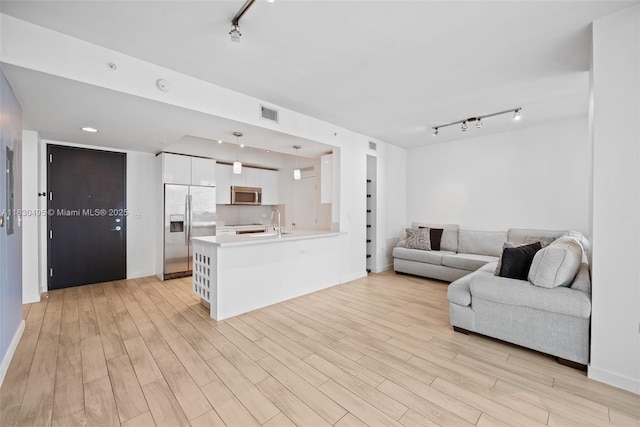 999 SW 1st Ave Unit 1615, Miami, FL 33130 - living area featuring rail lighting and light wood-style floors