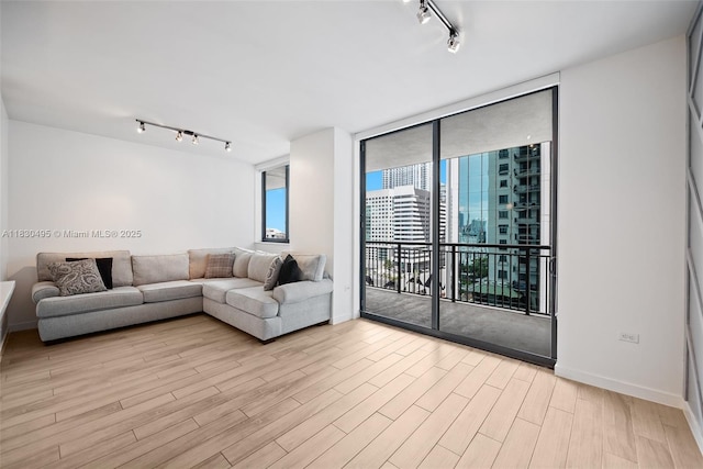 999 SW 1st Ave Unit 1615, Miami, FL 33130 - living area with track lighting, floor to ceiling windows, and light wood-style flooring