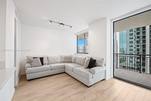 999 SW 1st Ave Unit 1615, Miami, FL 33130 - living area with plenty of natural light, light wood-type flooring, floor to ceiling windows, and rail lighting