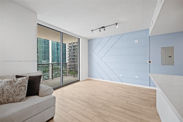 999 SW 1st Ave Unit 1615, Miami, FL 33130 - living area with electric panel, a wall of windows, light wood-style floors, and track lighting