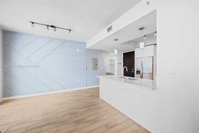 999 SW 1st Ave Unit 1615, Miami, FL 33130 - kitchen featuring stainless steel refrigerator with ice dispenser, rail lighting, a peninsula, light wood-style floors, and hanging light fixtures