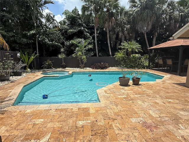 8878 SW 59th St, Cooper City, FL 33328 - view of swimming pool featuring a patio area, a gazebo, a fenced backyard, and a pool with connected hot tub