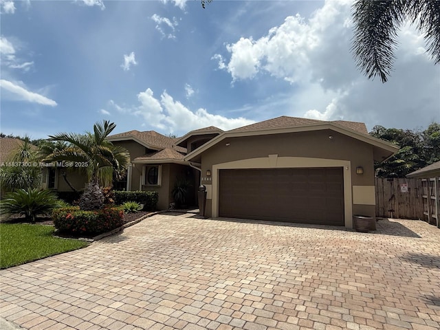 8878 SW 59th St, Cooper City, FL 33328 - view of front of house featuring stucco siding, an attached garage, and decorative driveway