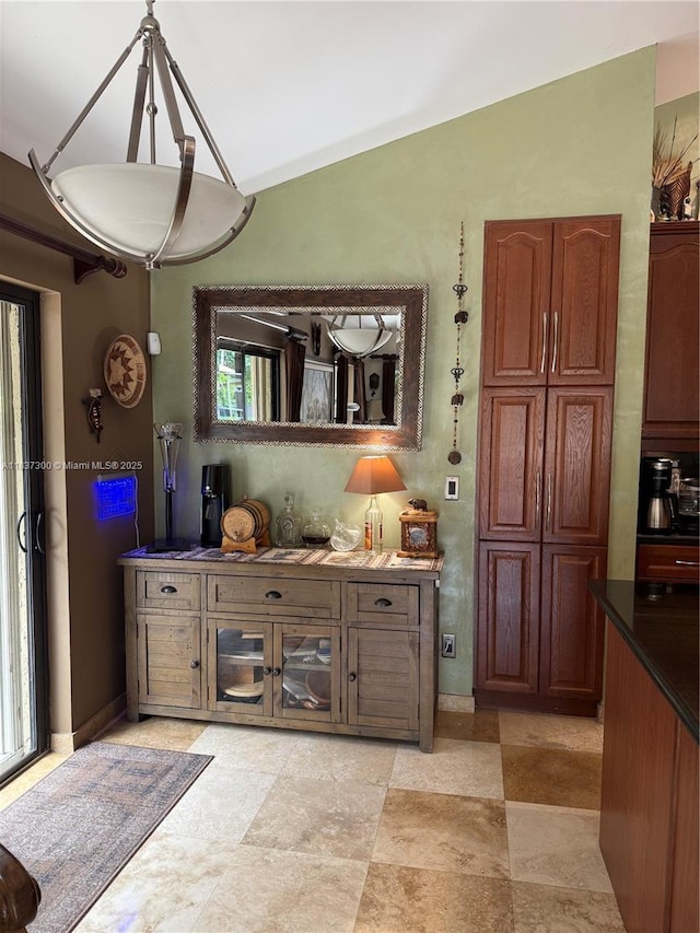 8878 SW 59th St, Cooper City, FL 33328 - kitchen with vaulted ceiling, dark countertops, and brown cabinetry