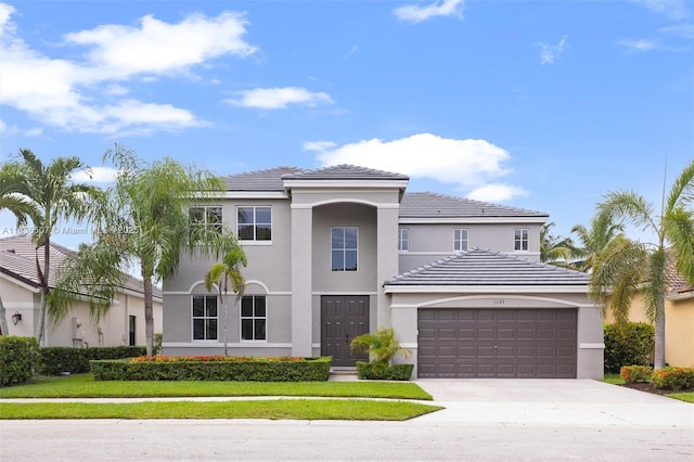 1249 Chenille Cir, Weston, FL 33327 - view of front of property featuring an attached garage, driveway, stucco siding, and a tile roof