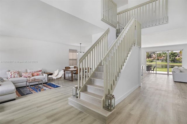 1249 Chenille Cir, Weston, FL 33327 - stairs with a high ceiling, wood finished floors, and a chandelier