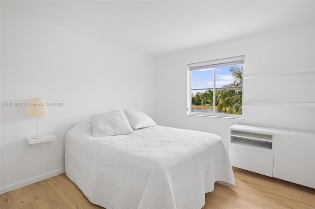1249 Chenille Cir, Weston, FL 33327 - bedroom with light wood-style flooring and baseboards