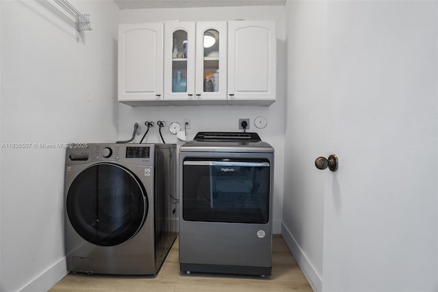 1249 Chenille Cir, Weston, FL 33327 - washroom with cabinet space, separate washer and dryer, and light wood-style floors