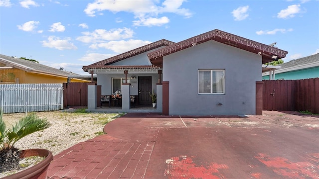 3109 NW 64th St, Miami, FL 33147 - rear view of house with a gate, stucco siding, and a patio area