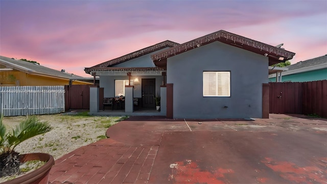3109 NW 64th St, Miami, FL 33147 - rear view of property with a gate, a patio area, and stucco siding
