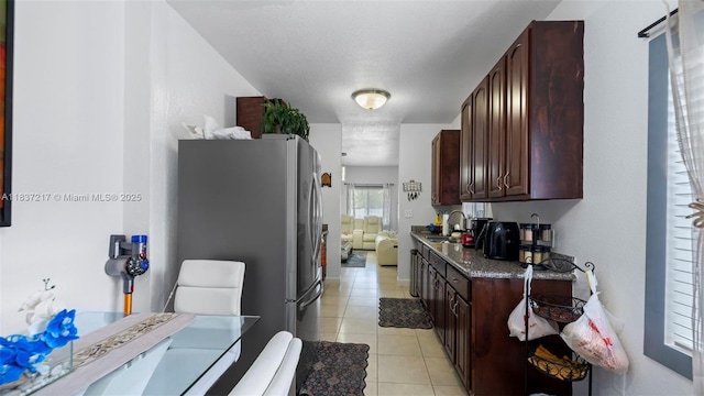 3109 NW 64th St, Miami, FL 33147 - kitchen featuring freestanding refrigerator, light tile patterned floors, and dark brown cabinetry