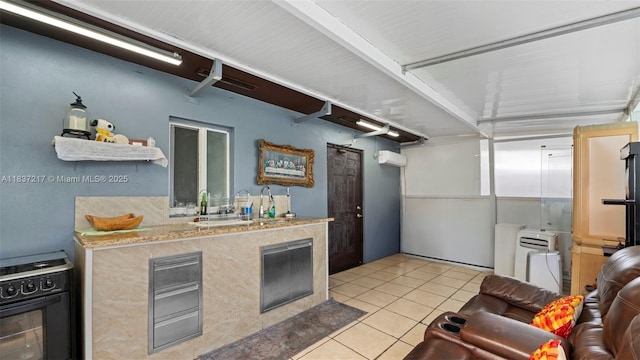 3109 NW 64th St, Miami, FL 33147 - kitchen featuring black gas stove and light tile patterned floors