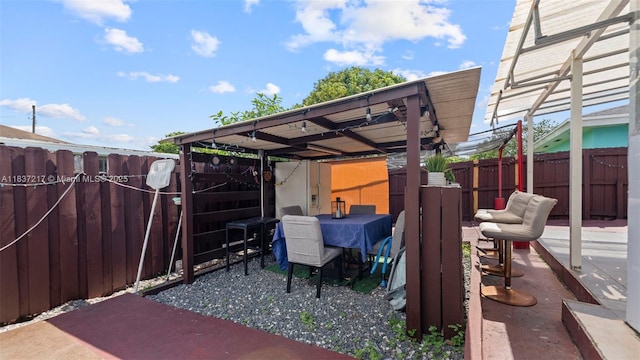 3109 NW 64th St, Miami, FL 33147 - fenced backyard featuring a patio and outdoor dining area