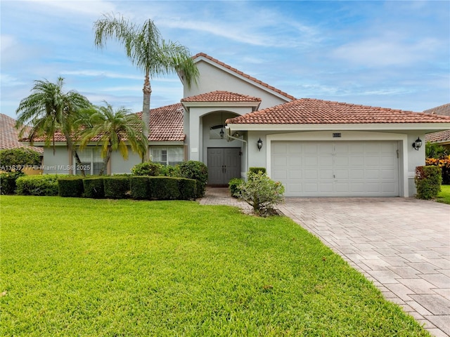 6110 Pitch Ln, Boynton Beach, FL 33437 - mediterranean / spanish-style house with stucco siding, decorative driveway, a front lawn, a garage, and a tiled roof