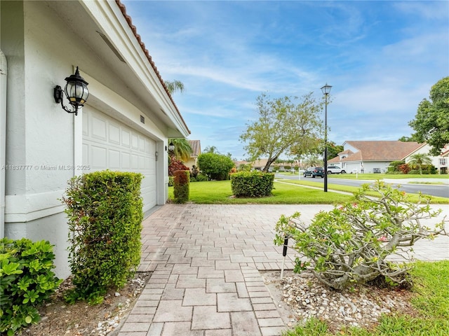 6110 Pitch Ln, Boynton Beach, FL 33437 - view of patio featuring driveway, a residential view, and a garage