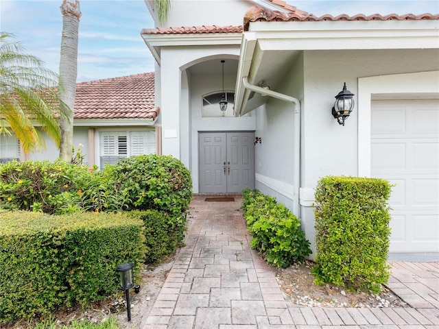 6110 Pitch Ln, Boynton Beach, FL 33437 - entrance to property featuring stucco siding, a tile roof, and an attached garage